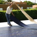 Thin-film solar photovoltiac modules being installed ona roof. Click for more info on thin-film PV
