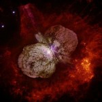 Eta Carinae and the lobed Homunculus Nebula which surrounds the star[s]. The massive blue-giant  appears as the white patch near the center of the image, where the 2 lobes. Image courtesy of the Hubble