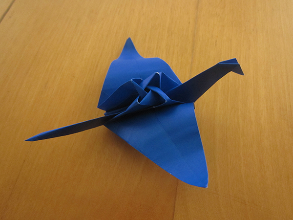 Shown: a paper crane, but the back of the crane is a four-petaled rose