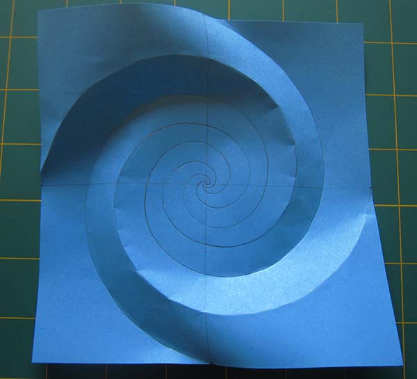 A paper with spirals traced on it, but only the outer edges of the spiral are creased