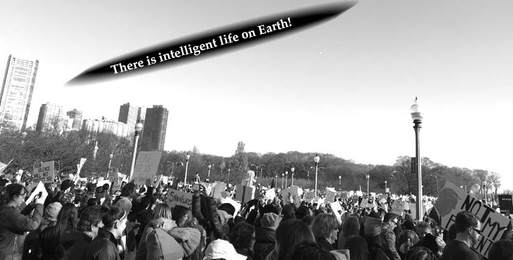 Women and women marching.  Above them, a UFO has the text, "There is intelligent life on Earth!"