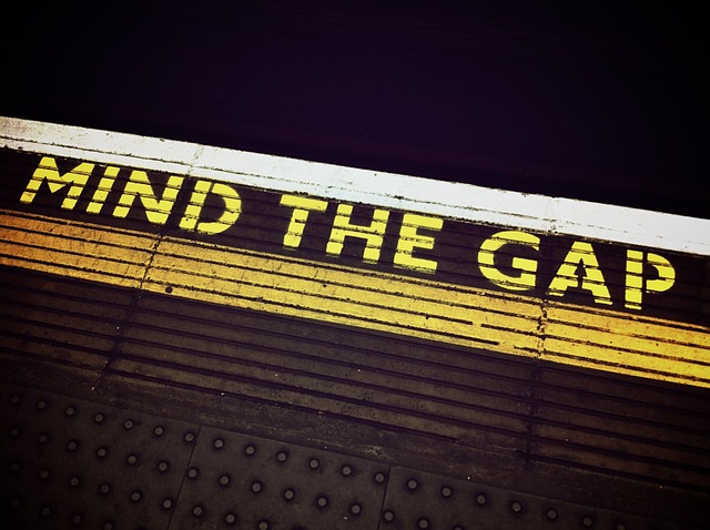 A subway platform sign reading "Mind the Gap"