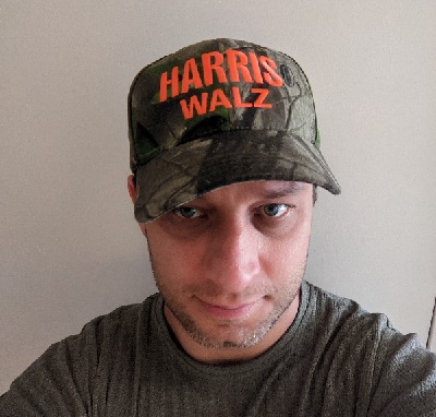 The author in a Harris-Walz camo hat