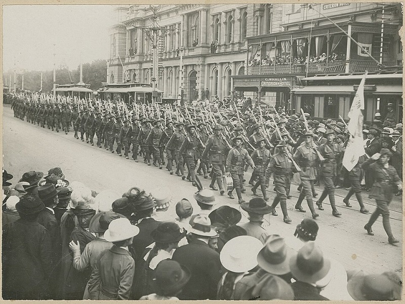 A black-and-white photo of soldiers marching on parade