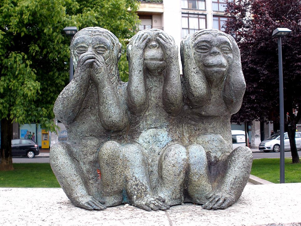 A statue of the "see no evil, hear no evil, speak no evil" monkeys