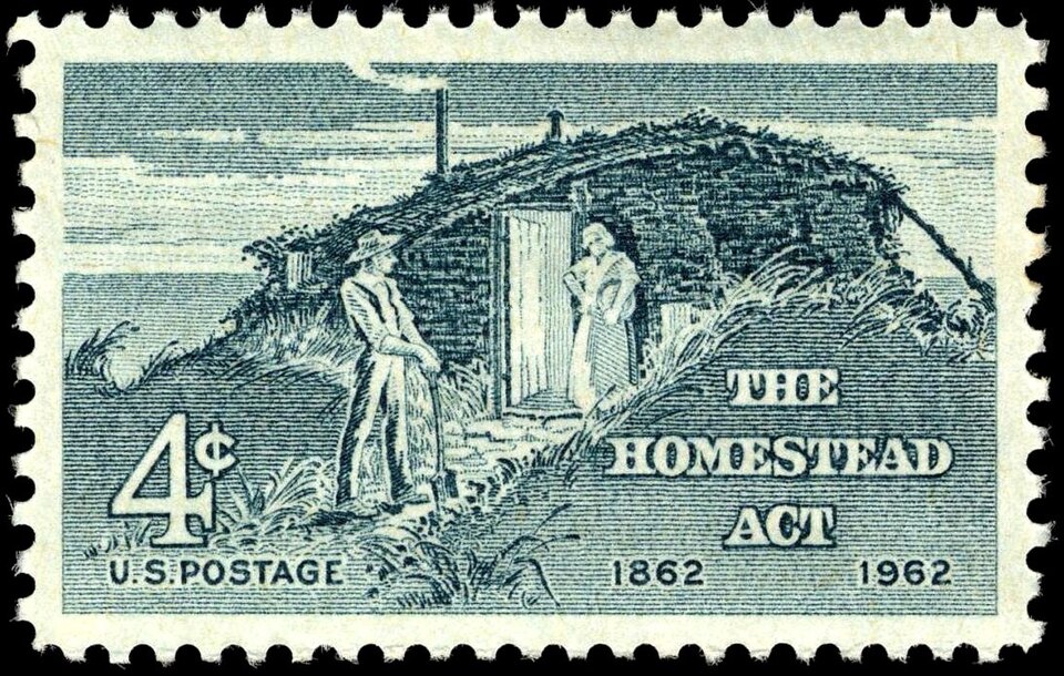 A "Homestead Act" stamp showing white settlers of the West