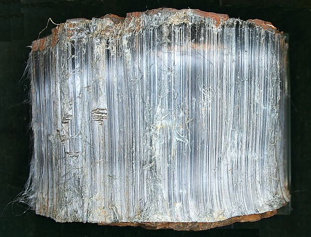 Image shows a piece of crocidolite, which looks rather like unpolished Tiger's Eye, except it's various shades of blue.