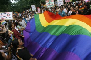 Gay rights activists display a rainbow flag during "Queer Pride March" in New Delhi